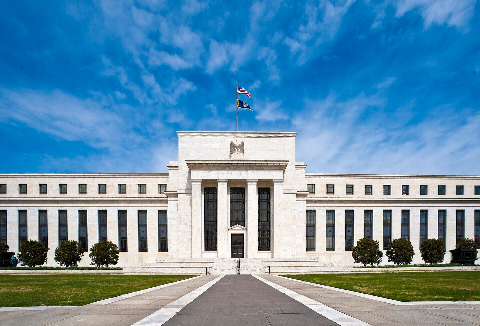 The Eccles Building, headquarters of the Federal Reserve, under a blue sky
