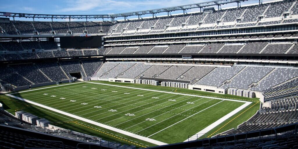 Empty MetLife Stadium field viewed from the stands on a clear day