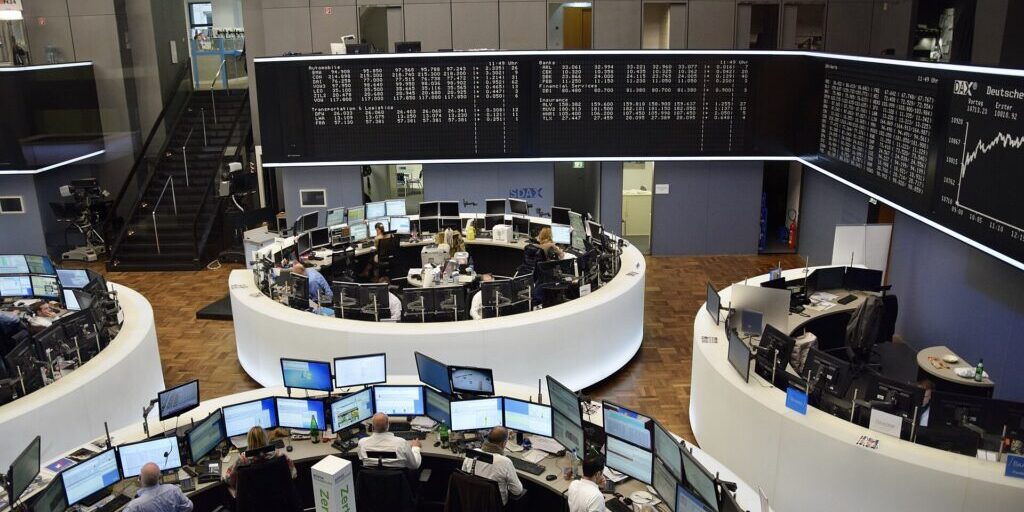Trading floor at Frankfurt Stock Exchange with workstations and overhead ticker displays