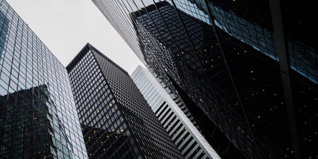 Modern office buildings in a financial district, shot from below looking upward