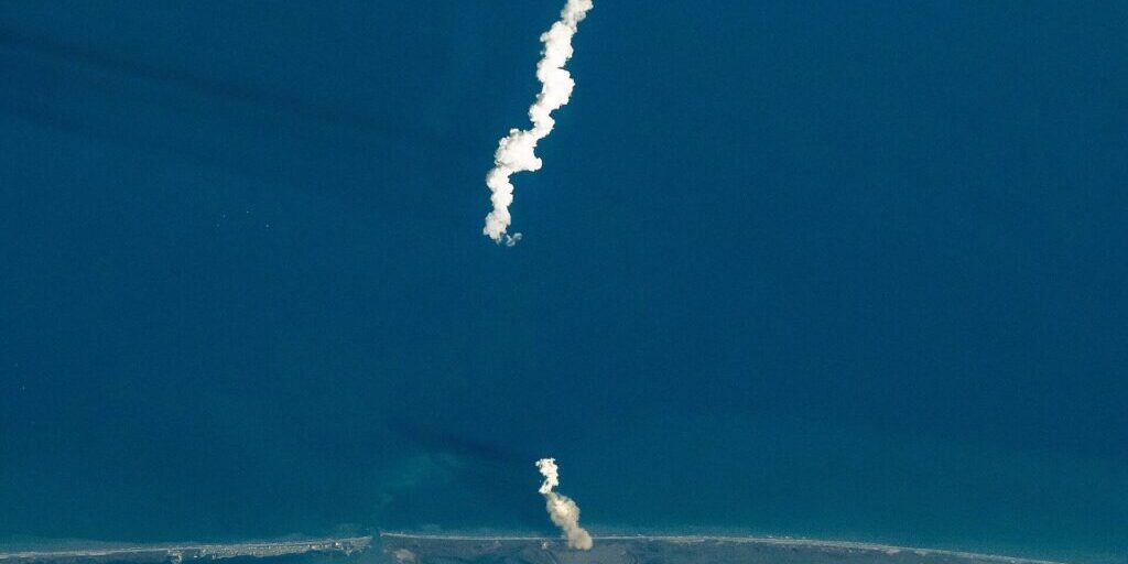 Starship launch plume rising over ocean, photographed from the International Space Station