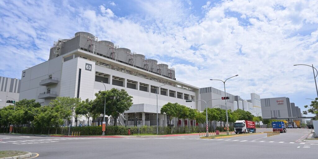 TSMC Fab 18 manufacturing complex in Southern Taiwan Science Park, with white and grey industrial buildings and clear sky