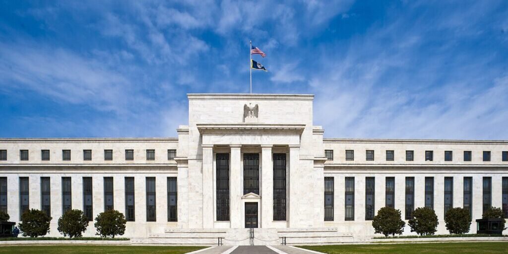 The Eccles Building, headquarters of the Federal Reserve, under a blue sky